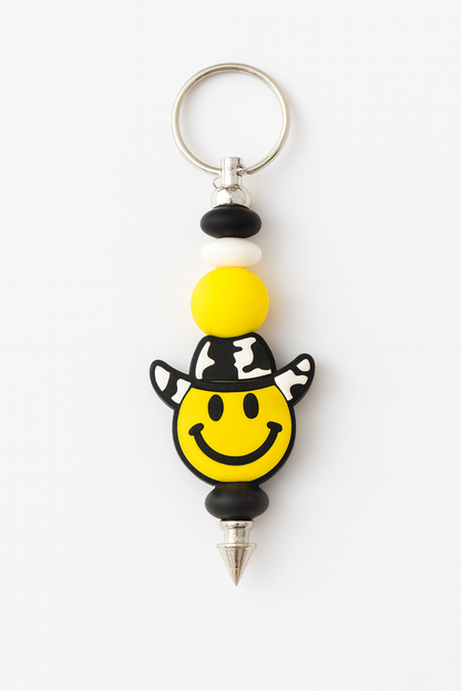 Yellow smiley face cowboy charm keychain with black and white silicone beads