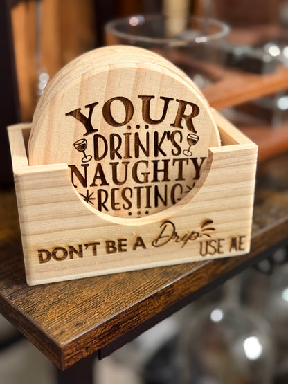 Set of six round wooden coasters engraved with funny and naughty drink sayings displayed together.